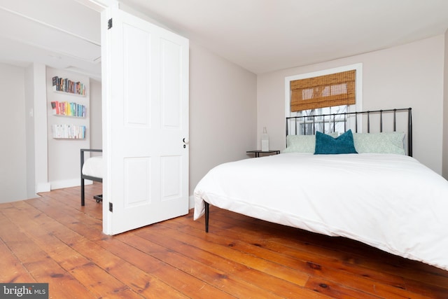 bedroom with hardwood / wood-style floors