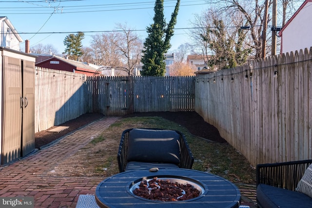 view of yard featuring a patio and a fire pit