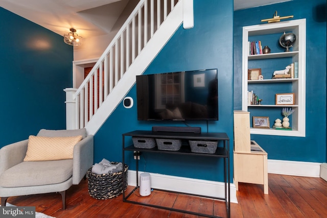 living room featuring built in features and hardwood / wood-style floors