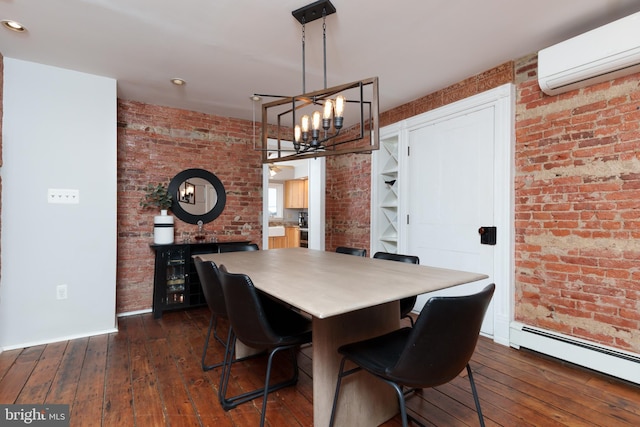 dining area featuring baseboard heating, brick wall, dark wood-type flooring, an inviting chandelier, and a wall unit AC