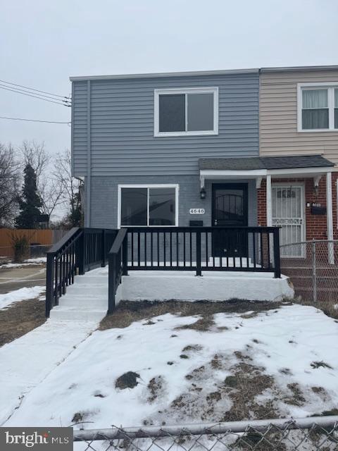 view of snow covered rear of property