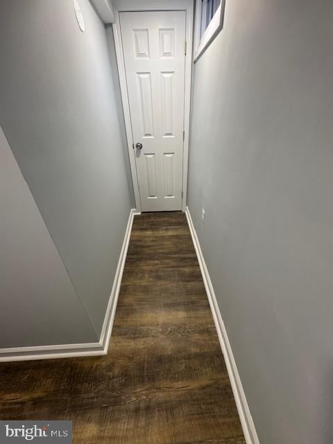 hallway with dark hardwood / wood-style flooring