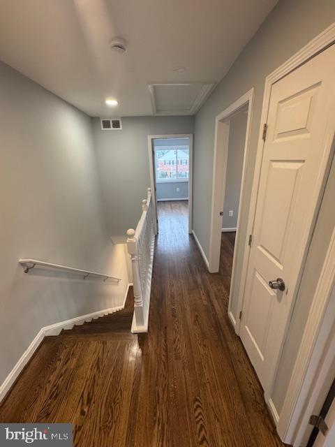 corridor featuring dark hardwood / wood-style floors