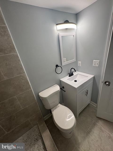 bathroom featuring toilet and vanity