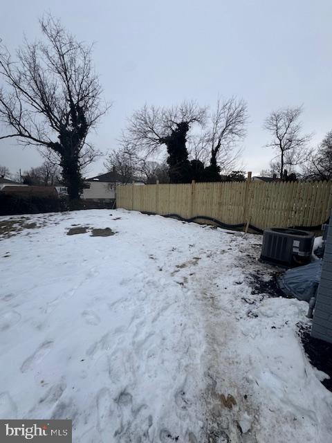 yard covered in snow featuring central air condition unit