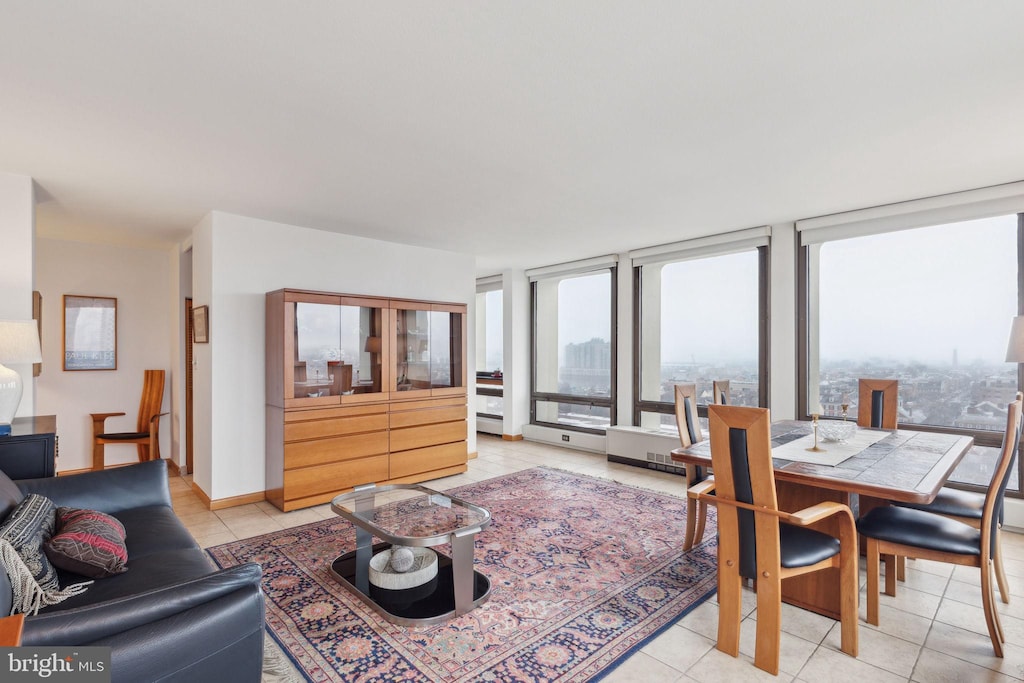 tiled living room featuring floor to ceiling windows