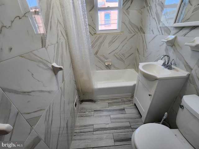 full bathroom featuring toilet, shower / tub combo, tile walls, and vanity