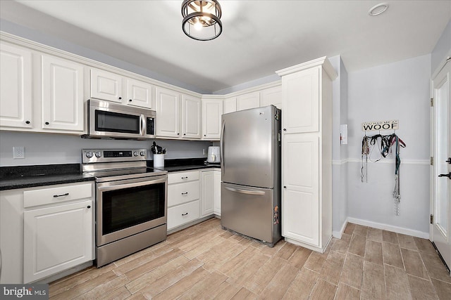 kitchen featuring stainless steel appliances and white cabinets