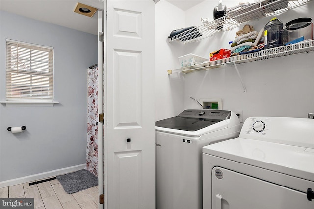 laundry room featuring washing machine and clothes dryer