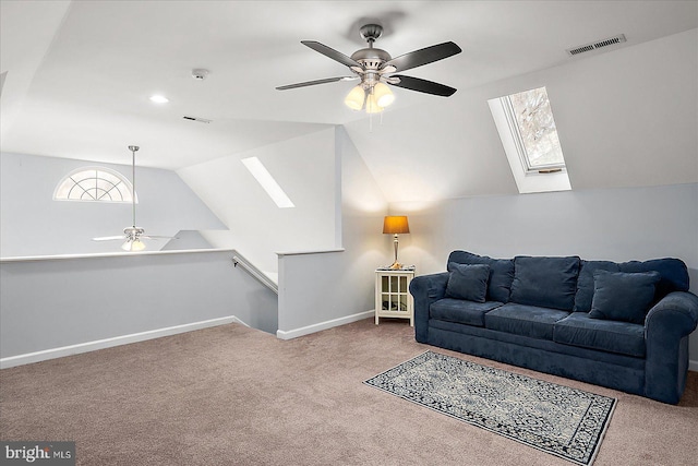 living room with ceiling fan, carpet flooring, and vaulted ceiling with skylight