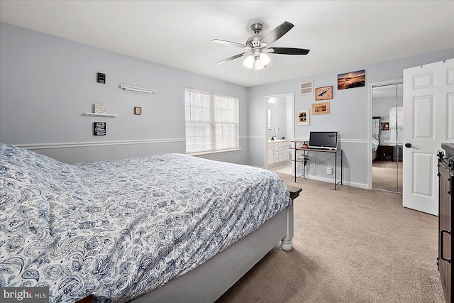 carpeted bedroom with ceiling fan, ensuite bath, and a closet