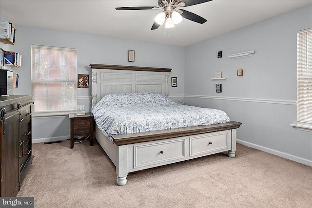 bedroom with light carpet and ceiling fan