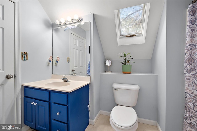 bathroom with toilet, lofted ceiling with skylight, and vanity