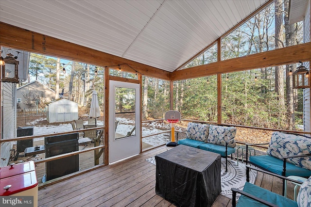 sunroom / solarium featuring lofted ceiling