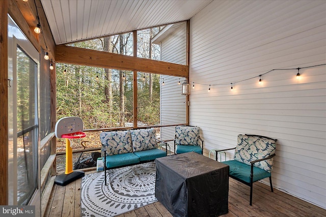 sunroom featuring vaulted ceiling