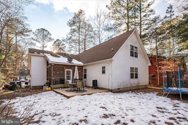 snow covered property featuring a trampoline