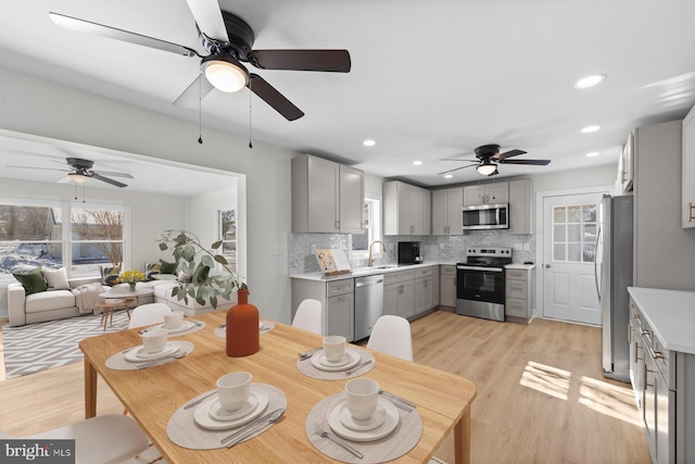 dining area featuring sink and light hardwood / wood-style floors