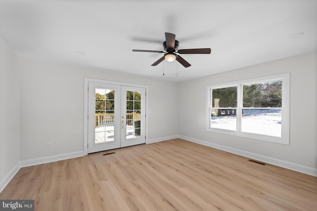 spare room with light hardwood / wood-style flooring, ceiling fan, and french doors