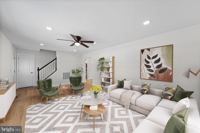 living room featuring light hardwood / wood-style floors and ceiling fan