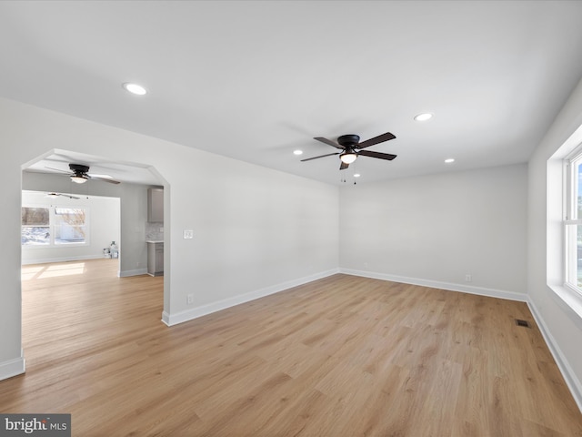 spare room featuring light hardwood / wood-style flooring and ceiling fan