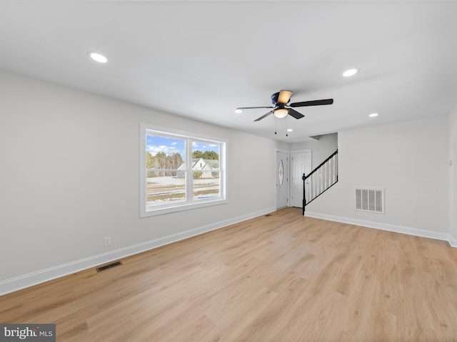 unfurnished living room with ceiling fan and light hardwood / wood-style floors