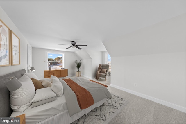 carpeted bedroom featuring ceiling fan and vaulted ceiling