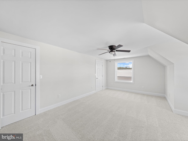 bonus room with ceiling fan, lofted ceiling, and light carpet