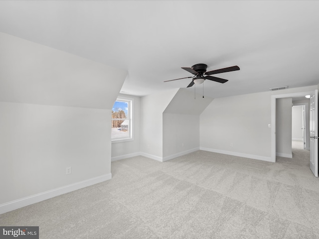 bonus room with lofted ceiling, light carpet, and ceiling fan