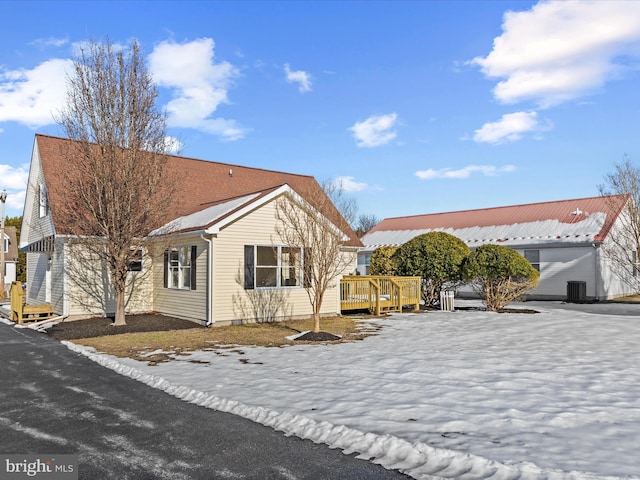 view of side of property featuring a deck and central air condition unit