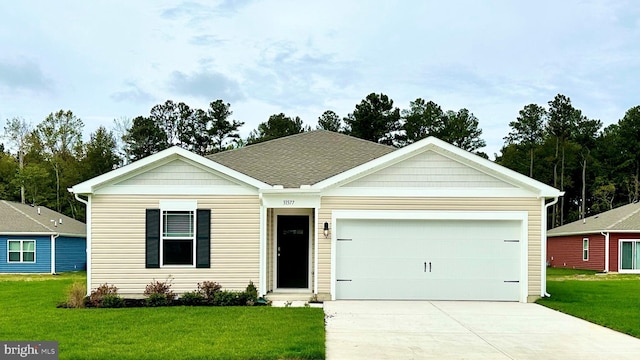 view of front of house with a front yard and a garage