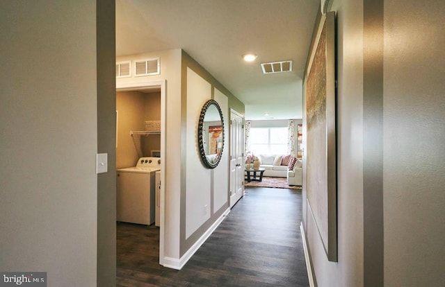 hallway featuring dark wood-type flooring and washer / clothes dryer
