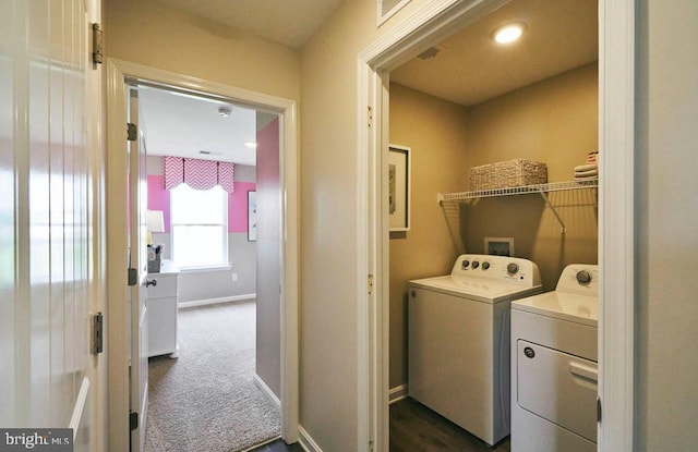 laundry room with washer and dryer and dark carpet