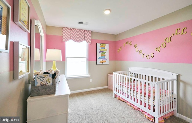 carpeted bedroom with a crib