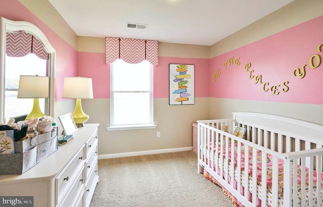 bedroom with carpet flooring and a nursery area