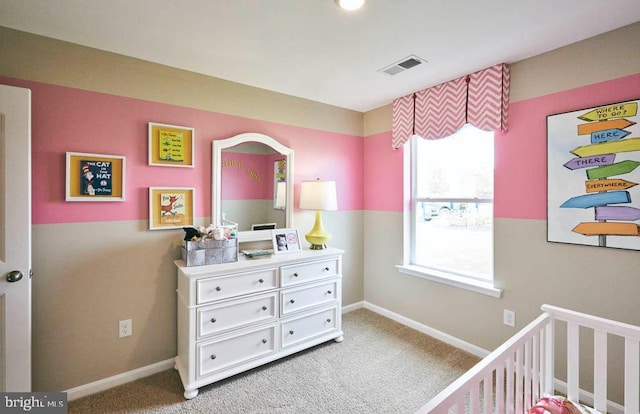 carpeted bedroom with a crib