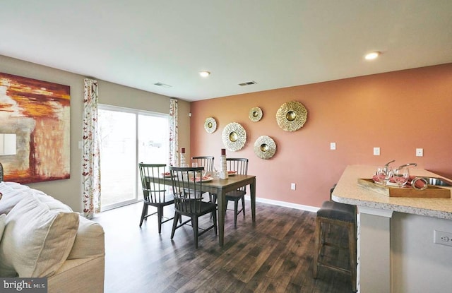dining area featuring dark hardwood / wood-style flooring and sink