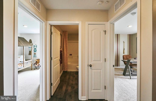 corridor featuring dark carpet
