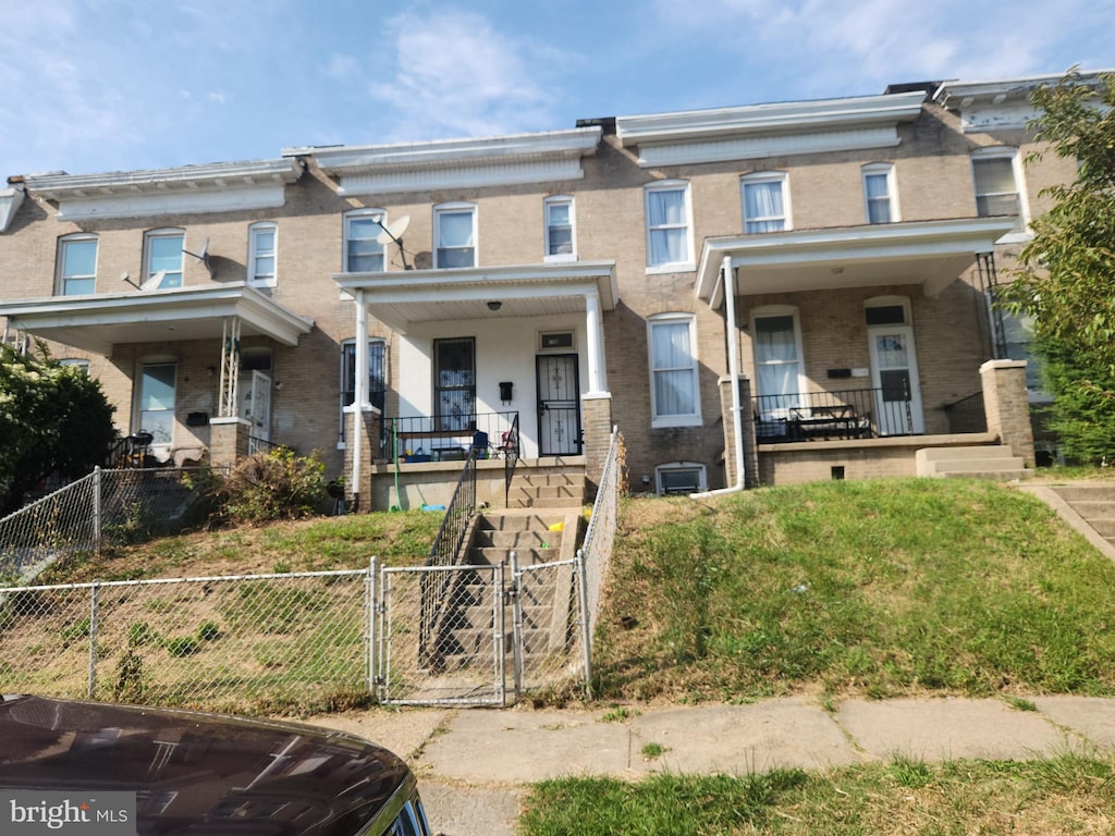 townhome / multi-family property featuring covered porch