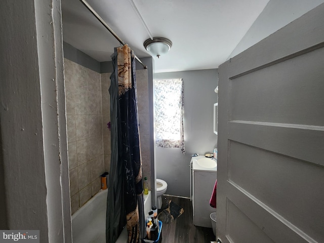 bathroom with toilet, hardwood / wood-style flooring, and shower / bath combo with shower curtain