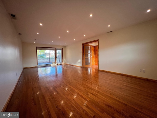 spare room with wood-type flooring