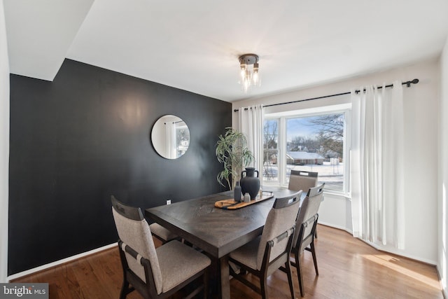 dining room with a chandelier and light hardwood / wood-style floors