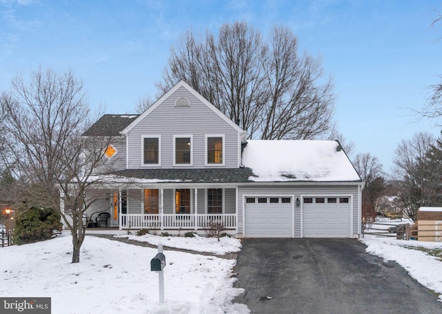 view of front of home featuring covered porch and a garage