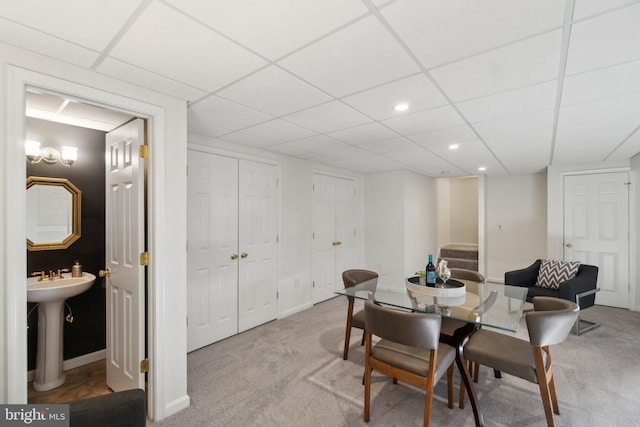 carpeted dining area with sink