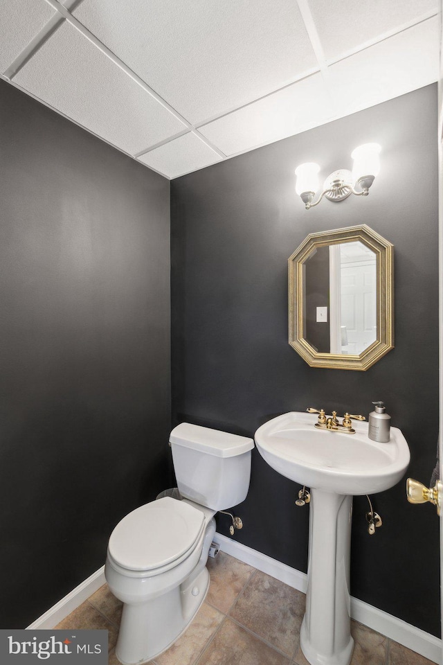 bathroom featuring toilet and tile patterned floors