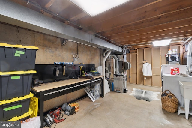 basement featuring heating unit and a workshop area