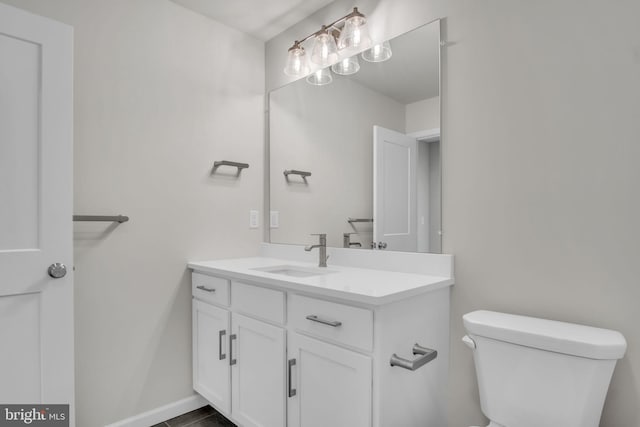 bathroom with toilet, tile patterned flooring, and vanity