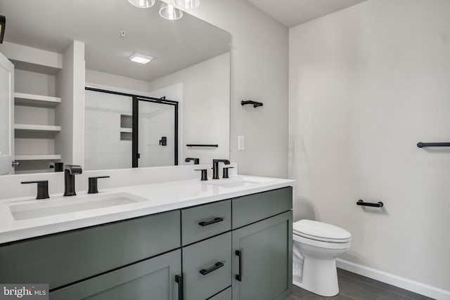 full bathroom with toilet, a shower stall, double vanity, and a sink