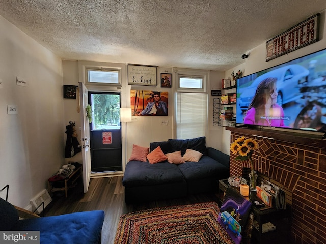 living room with a textured ceiling and hardwood / wood-style flooring