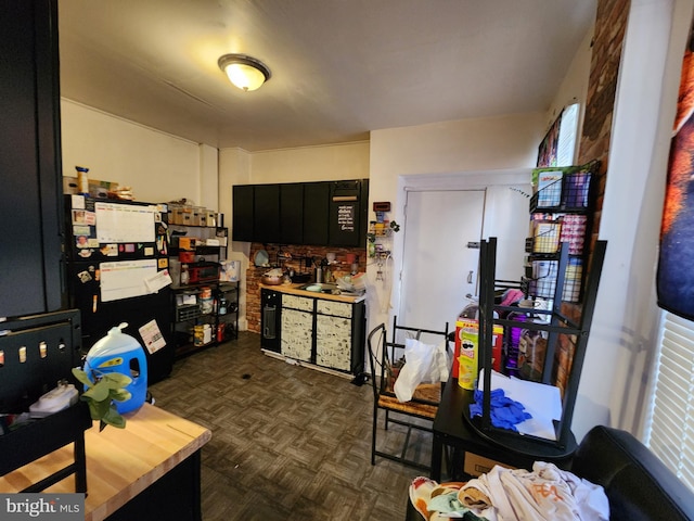 kitchen with black refrigerator and dark parquet floors