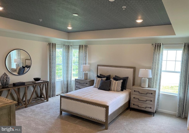 carpeted bedroom featuring multiple windows